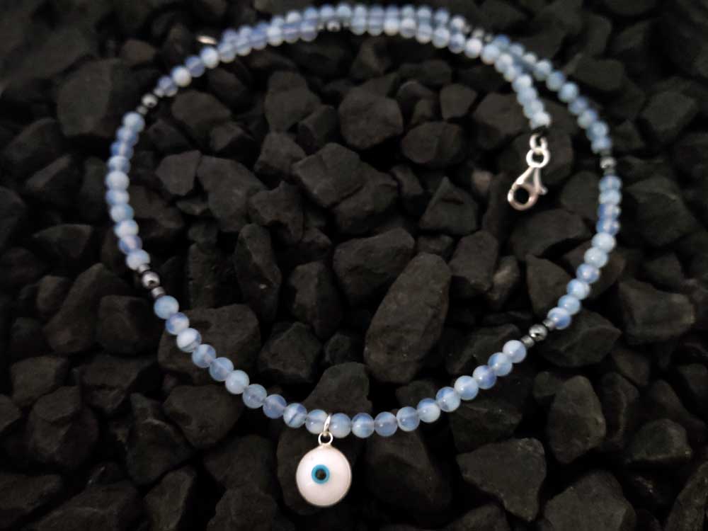 Handmade Sterling Silver Evil Eye Pendant with 4mm Moonstone and Hematite Beads, featuring a silver and white enamel Evil Eye design, 10mm wide, made in Greece.