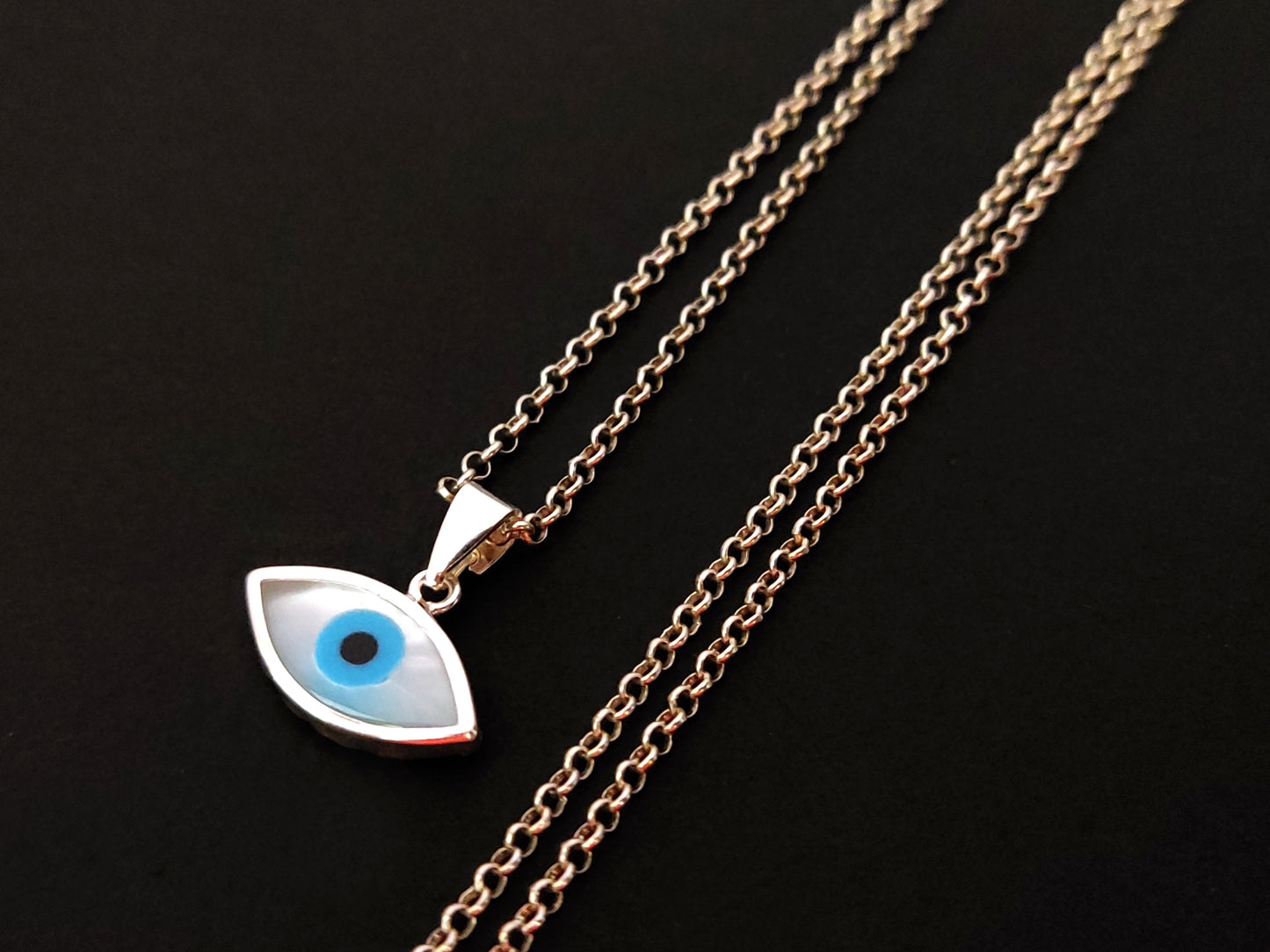 Close-up view of Greek Silver Mother of Pearl Evil Eye Pendant Necklace with intricate chain.
