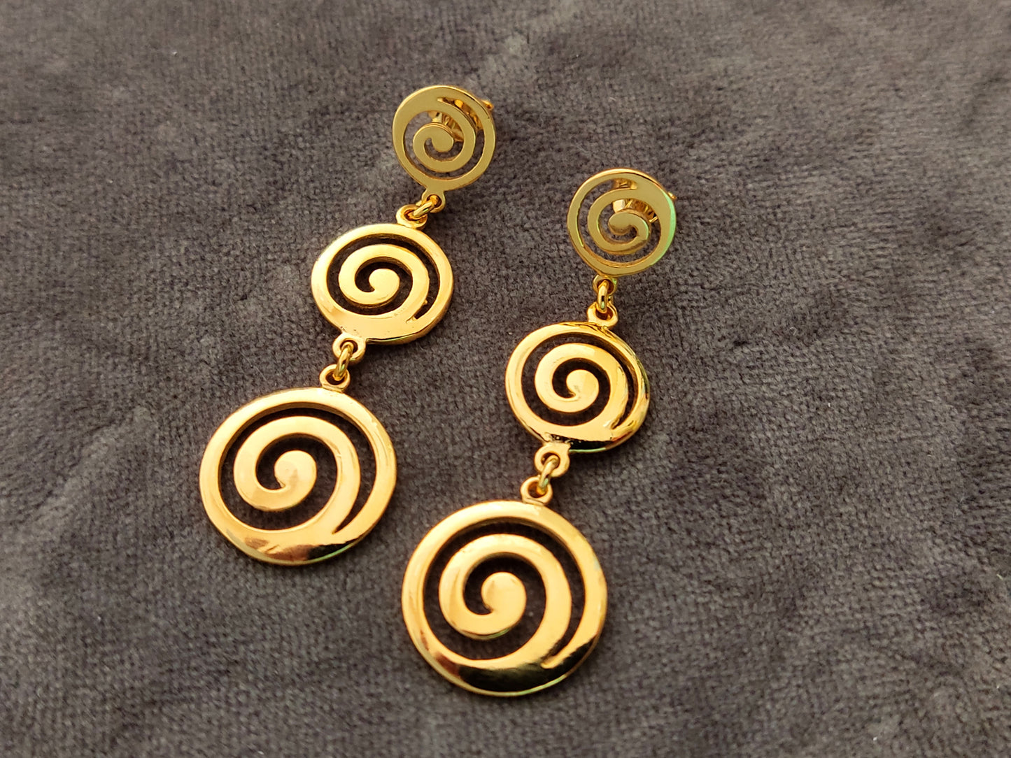 Greek spiral dangle long earrings made of Sterling Silver 925 with gold plated finish on gray velvet.