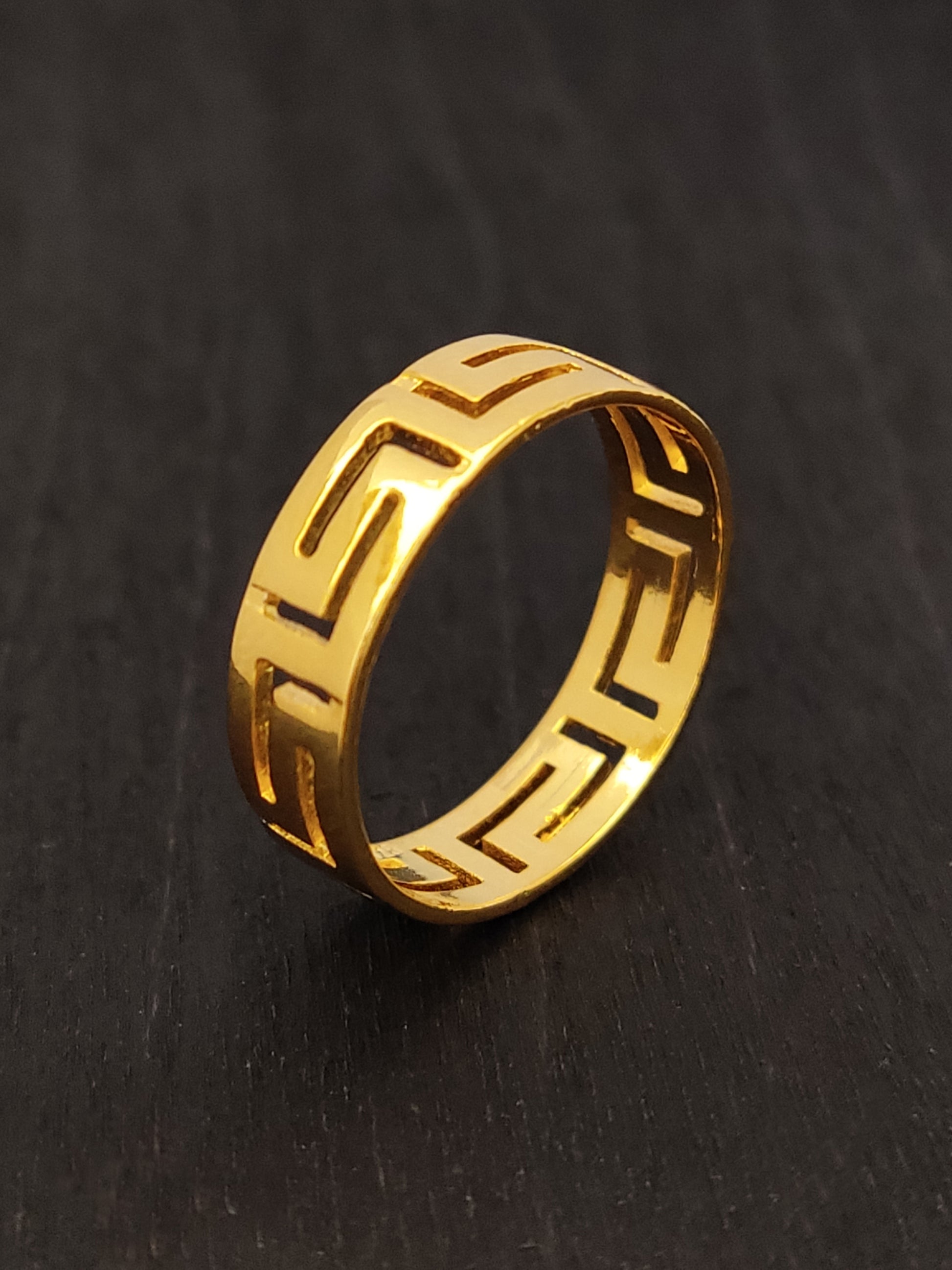 Greek key silver ring with gold plated finish measuring 5mm width on black background.
