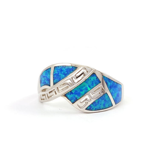 Silver ring with blue opal inlay on a white background