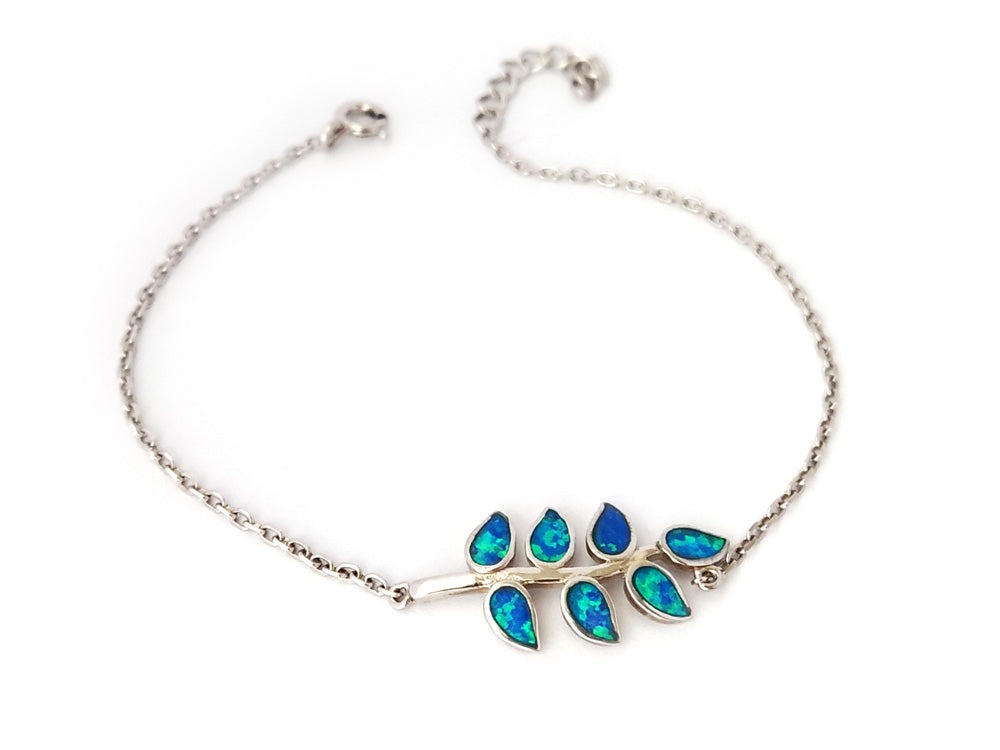 "Sterling silver bracelet with blue opal stones and olive leaves design, inspired by Greek mythology and Athena."
