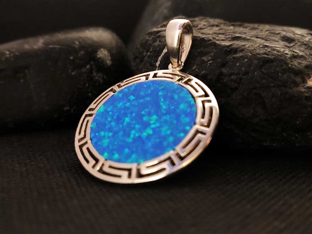 "Close-up view of Blue Opal Round Stone (2.4 mm) set in Sterling Silver 925 Greek Key pendant."
