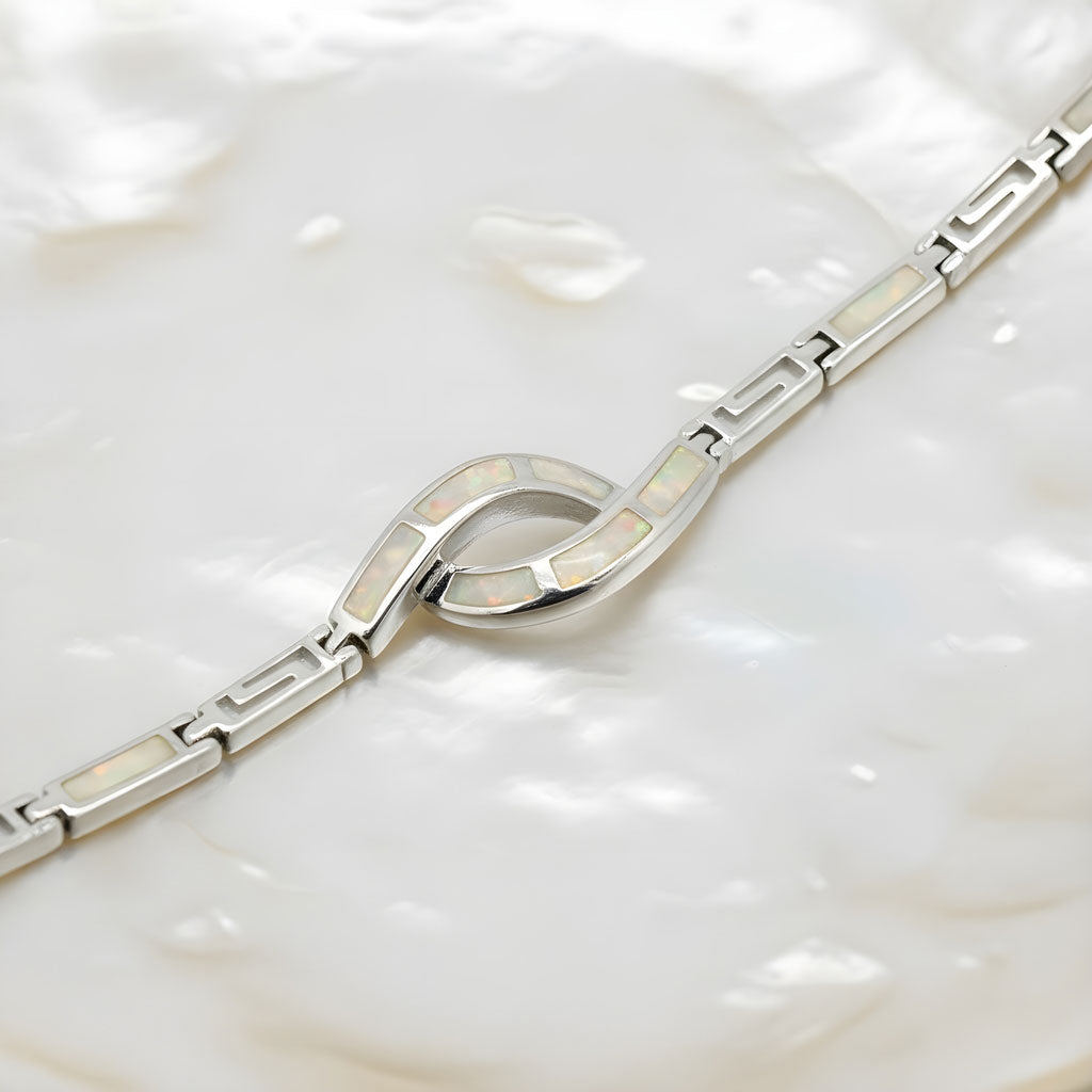 Sterling silver Greek key bracelet with white opal stones on wrist