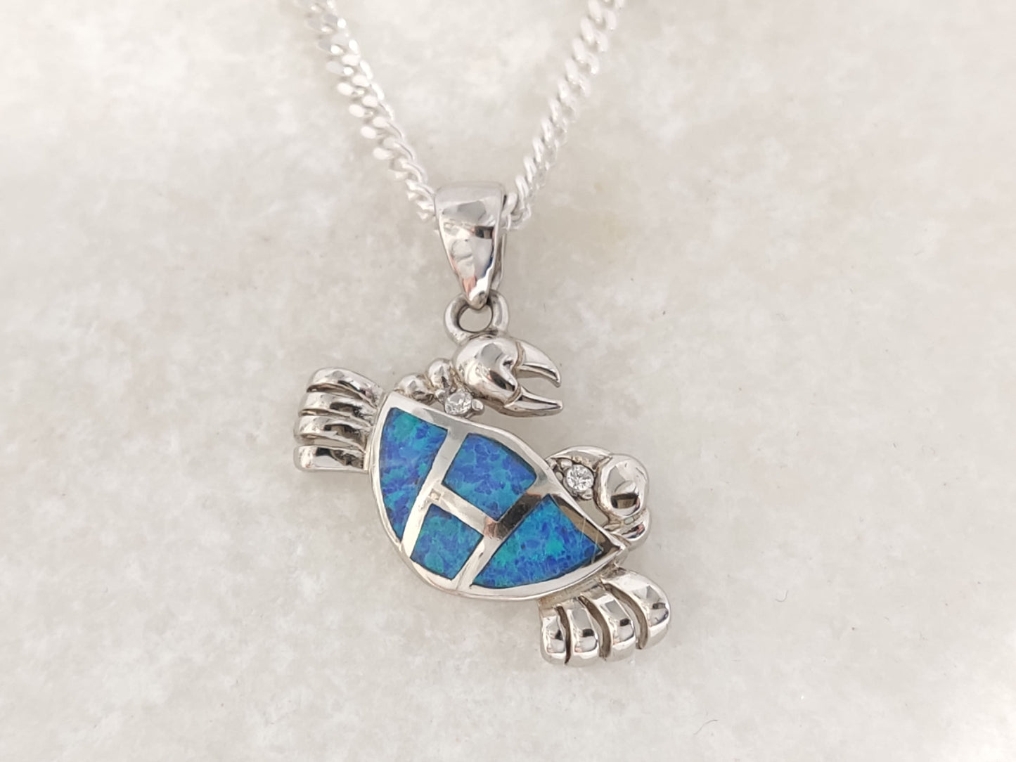 Elegant sterling silver crab charm with blue opal