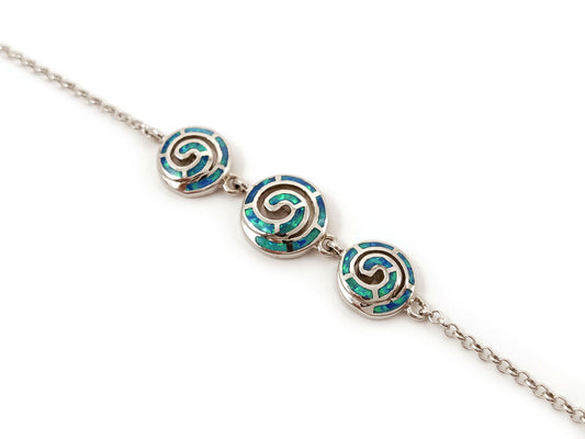 Sterling silver 925 bracelet featuring blue opal stones and a Greek spiral infinity design. Adjustable length from 17 to 20 cm (6.63 to 7.80 inches) with a 2 mm (0.07 inch) wide silver chain. Made in Greece with free worldwide shipping.