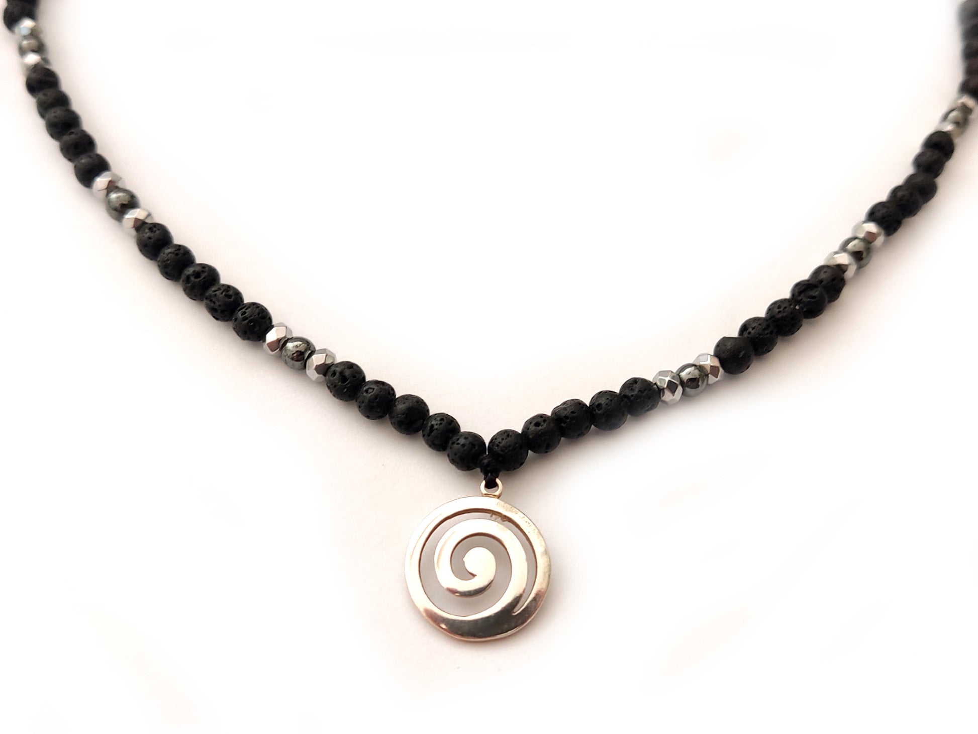Greek spiral infinity silver pendant with natural volcanic lava stones made as a necklace.