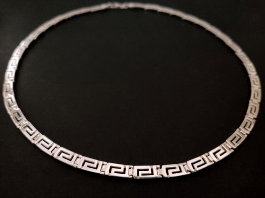 Greek key silver necklace on black bacground