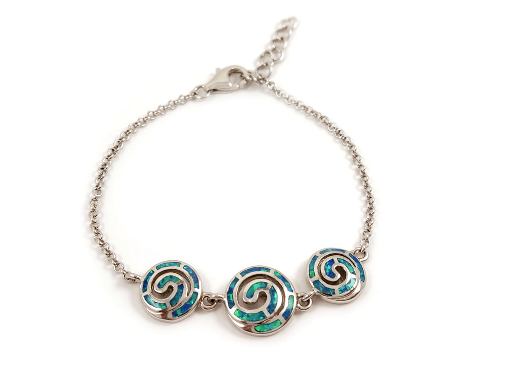 Greek-inspired jewelry piece made of sterling silver 925 with vibrant blue opal stones and intricate spiral infinity symbols. The spirals measure 10 mm (0.39 inches) and 12 mm (0.46 inches), with an adjustable length of 17 - 20 cm (6.63 - 7.80 inches). Crafted in Greece with free global shipping.