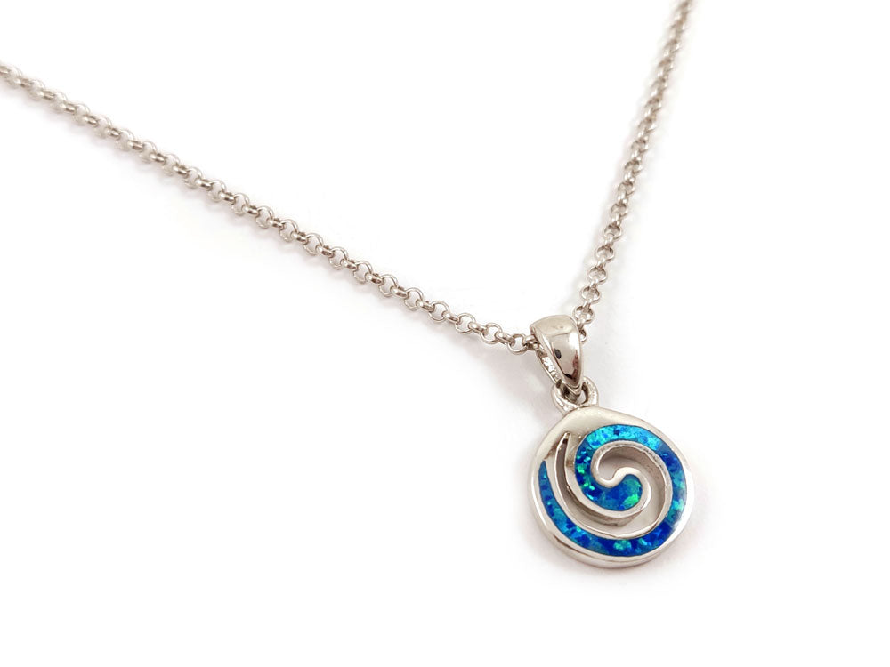 "Handmade in Greece, this Sterling Silver 925 pendant features a mesmerizing blue opal and unique Greek spiral motifs."

