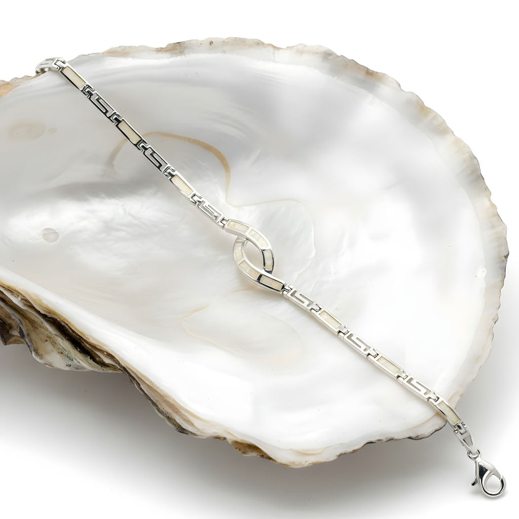 Close-up of 925 silver bracelet featuring Greek knot design and opals