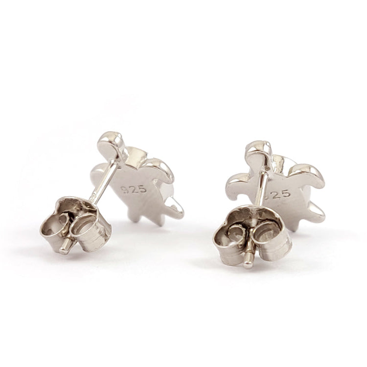 Silver puzzle piece earrings on a white background