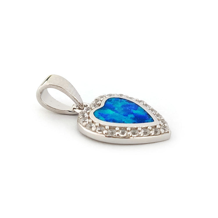 Close-up of Greek jewelry heart pendant with opal and cubic zirconia accents