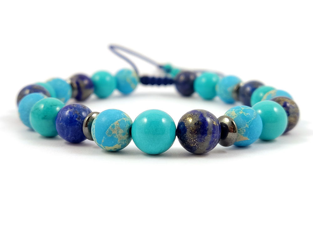 Elegant natural stone bracelet with 8mm Turquoise, Agate, and Lapis Lazuli beads, adjustable to fit most wrist sizes.
