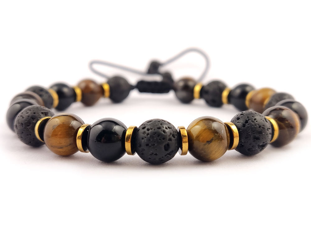 Close-up of Sirioti Jewelry Adjustable Bracelet: A detailed view showcasing the 8mm lava stones, tiger's eye, onyx, and gold-colored hematite elements in this handcrafted Greek design.

