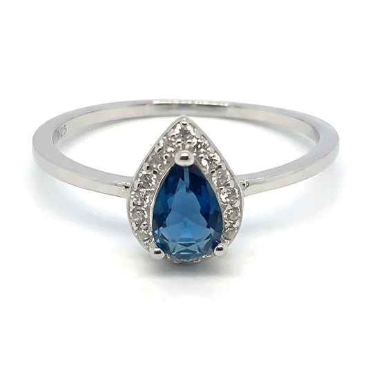 A sterling silver 925 ring featuring a pear-cut blue crystal stone surrounded by small clear accent stones, set on a plain white background.