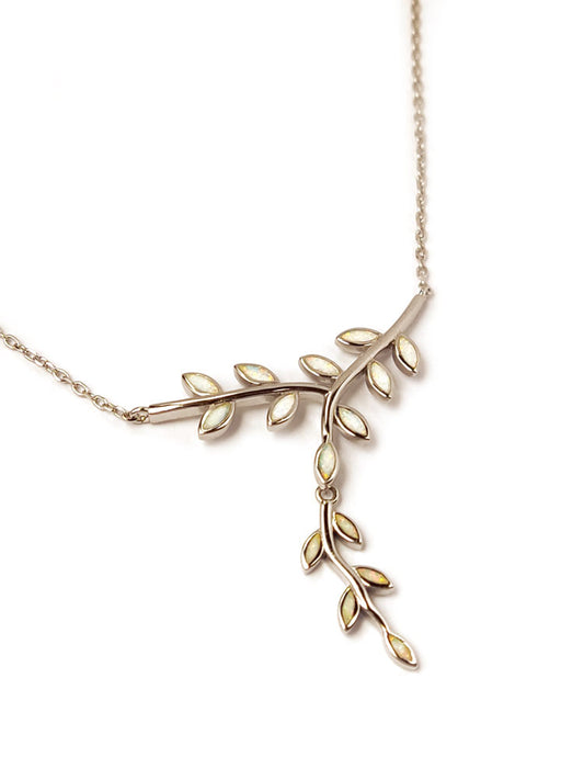 Olive leaves made of white opal stones decorate the center of a silver chain necklace from Greece.