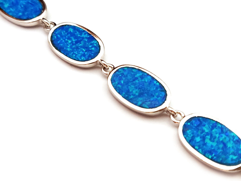 "Handmade Greek jewelry piece showcasing dazzling blue opals set in high-quality sterling silver."
