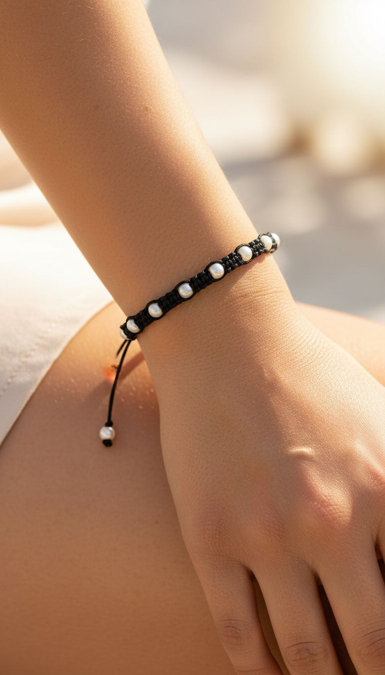 Handmade Greek macrame bracelet with pearls and black cord. adjustable length.