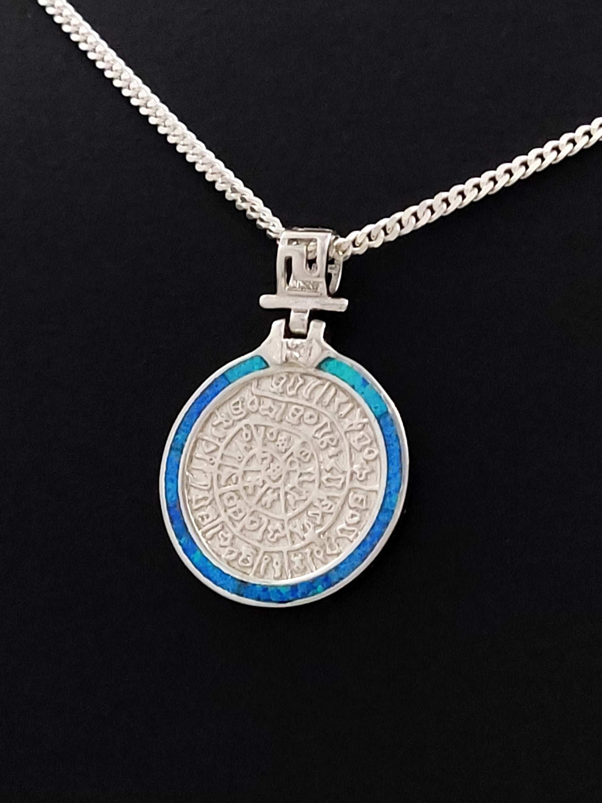Phaistos Disc Greek silver necklace with blue opal pendant measuring 22mm in diameter.