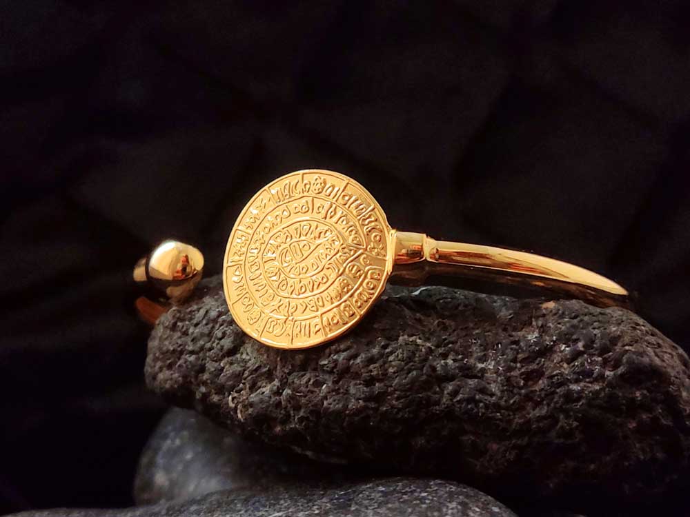 Close-up of Phaistos Disc bracelet – Showcasing the intricate 19mm (0.75 inches) engraved disc on a sterling silver cuff.

