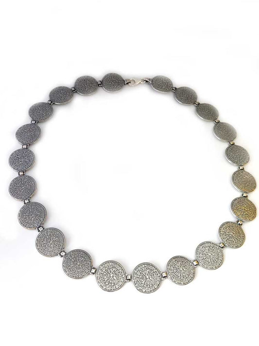Close-up view of our Phaistos Disc silver necklace measuring 16 mm in width by Sirioti Jewelry.