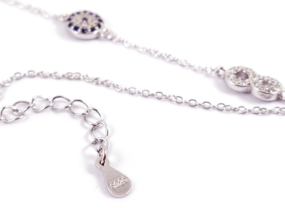 Sterling Silver Evil Eye Infinity Bracelet displayed on a soft background, highlighting its intricate details.
