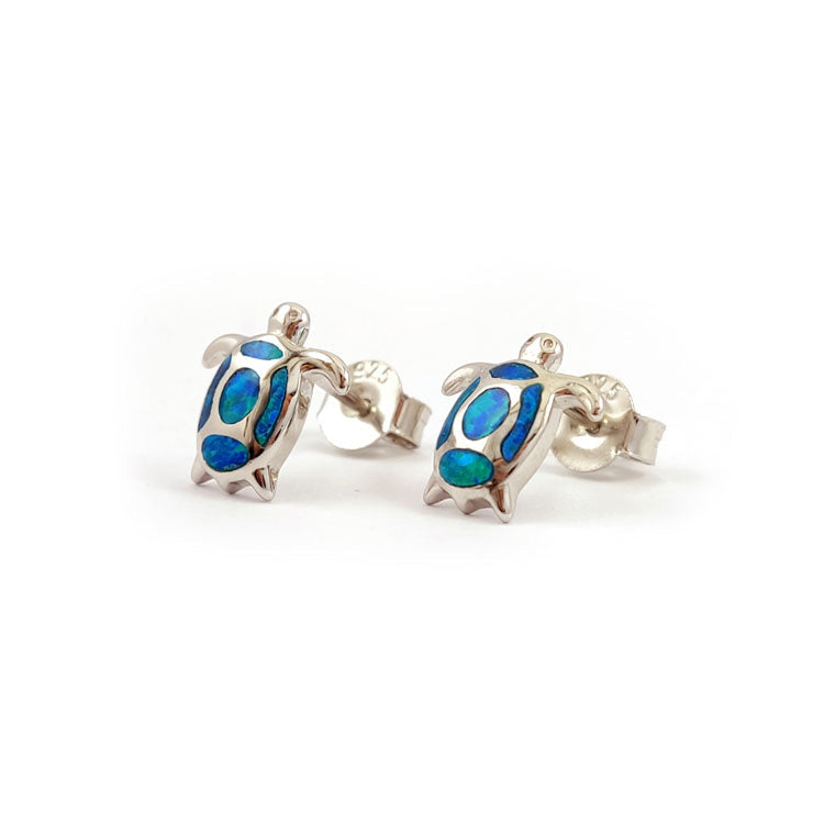 Turtle-shaped earrings with blue details on a white background