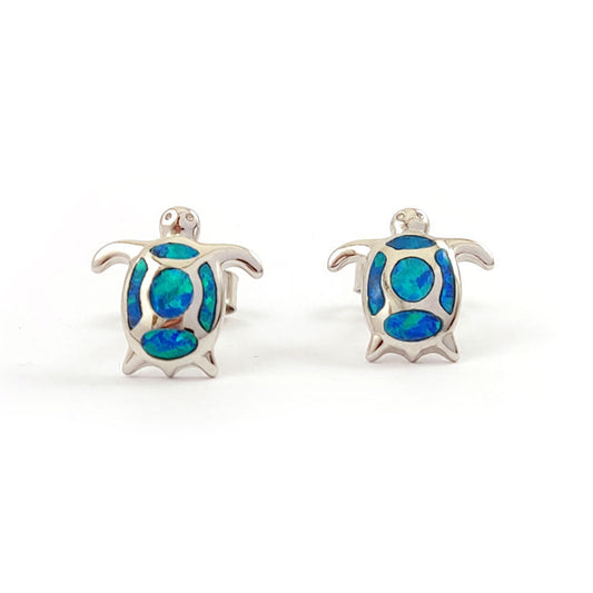 Turtle-shaped earrings with blue opal inlay on a white background