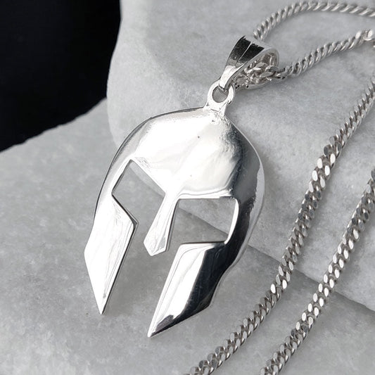 Silver pendant necklace on a stone surface