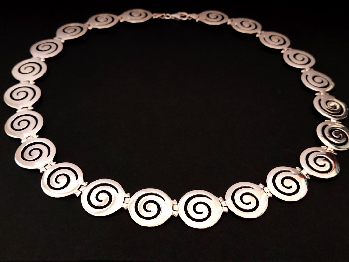 Greek silver necklace with spiral design measuring 19mm width.