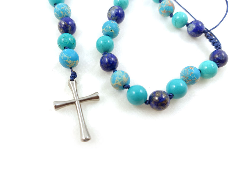 Elegant natural stone necklace styled with stainless steel cross pendant, perfect for layering or solo wear.