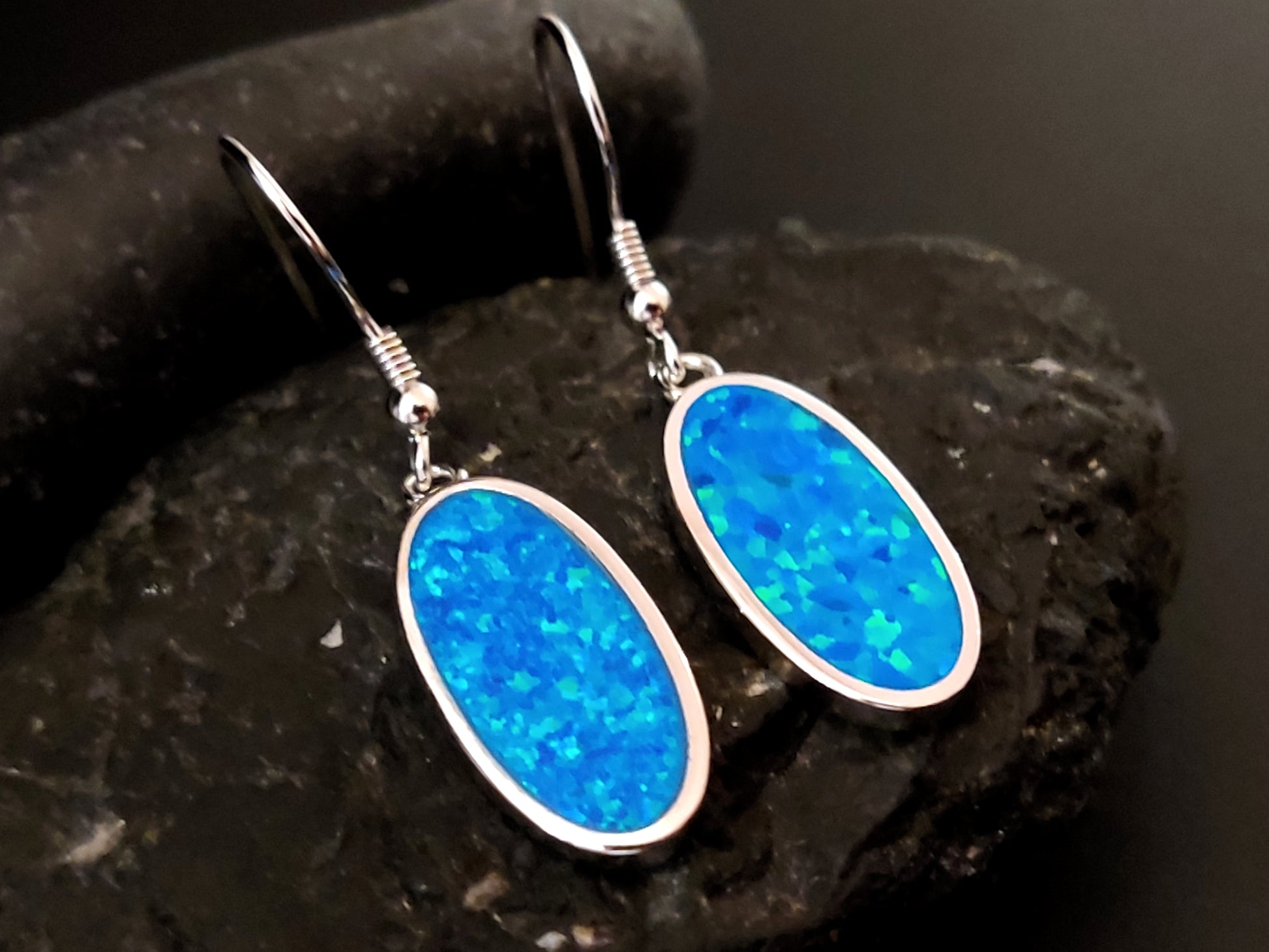 Blue Opal Oval Silver Dangle Greek Earrings 19x10mm - A pair of elegant silver earrings featuring stunning blue opal ovals, measuring 19x10mm, with intricate Greek-inspired detailing, perfect for adding timeless charm to your ensemble.