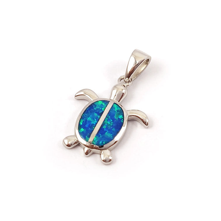 Turtle-shaped pendant with blue opal inset on a white background