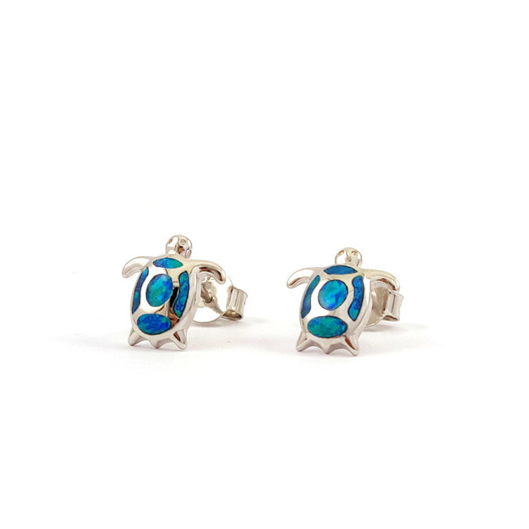 Turtle-shaped earrings with blue details on a white background