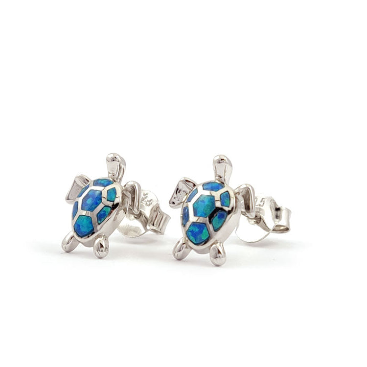 Turtle-shaped earrings with blue accents on a white background