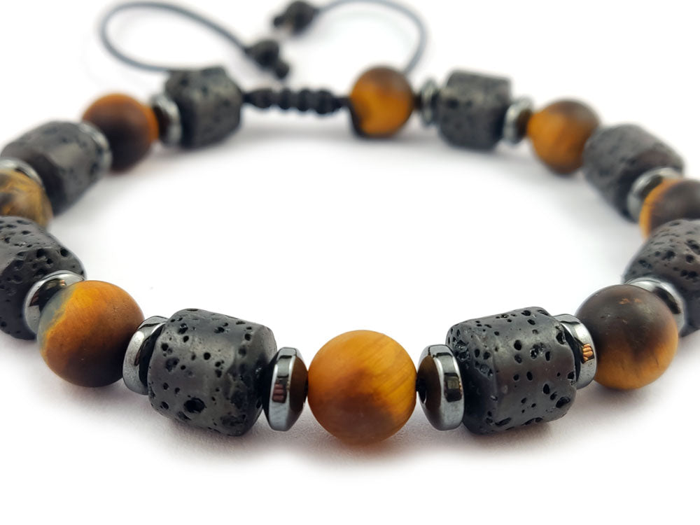 "A sleek and versatile lava and tiger's eye bracelet resting on a marble surface, showcasing its unique design and premium craftsmanship."

