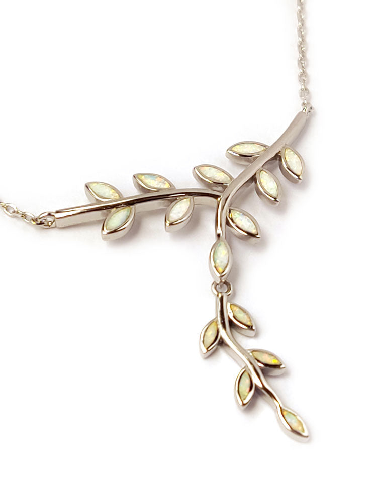 Sterling silver 925 chain necklace with white opal leaves in the middle. The necklace is set on white background.