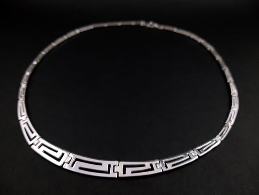 Greek Key necklace made of sterling silver 925 with a gradual pattern on black background.