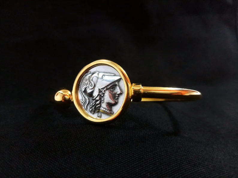 Bangle bracelet with goddess Athena in silver and gold color.