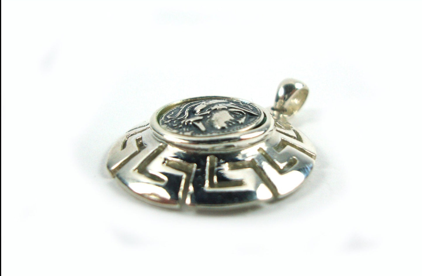 The side look of the Greek silver pendant that depicts goddess Athena and measuring 26mm in diameter.