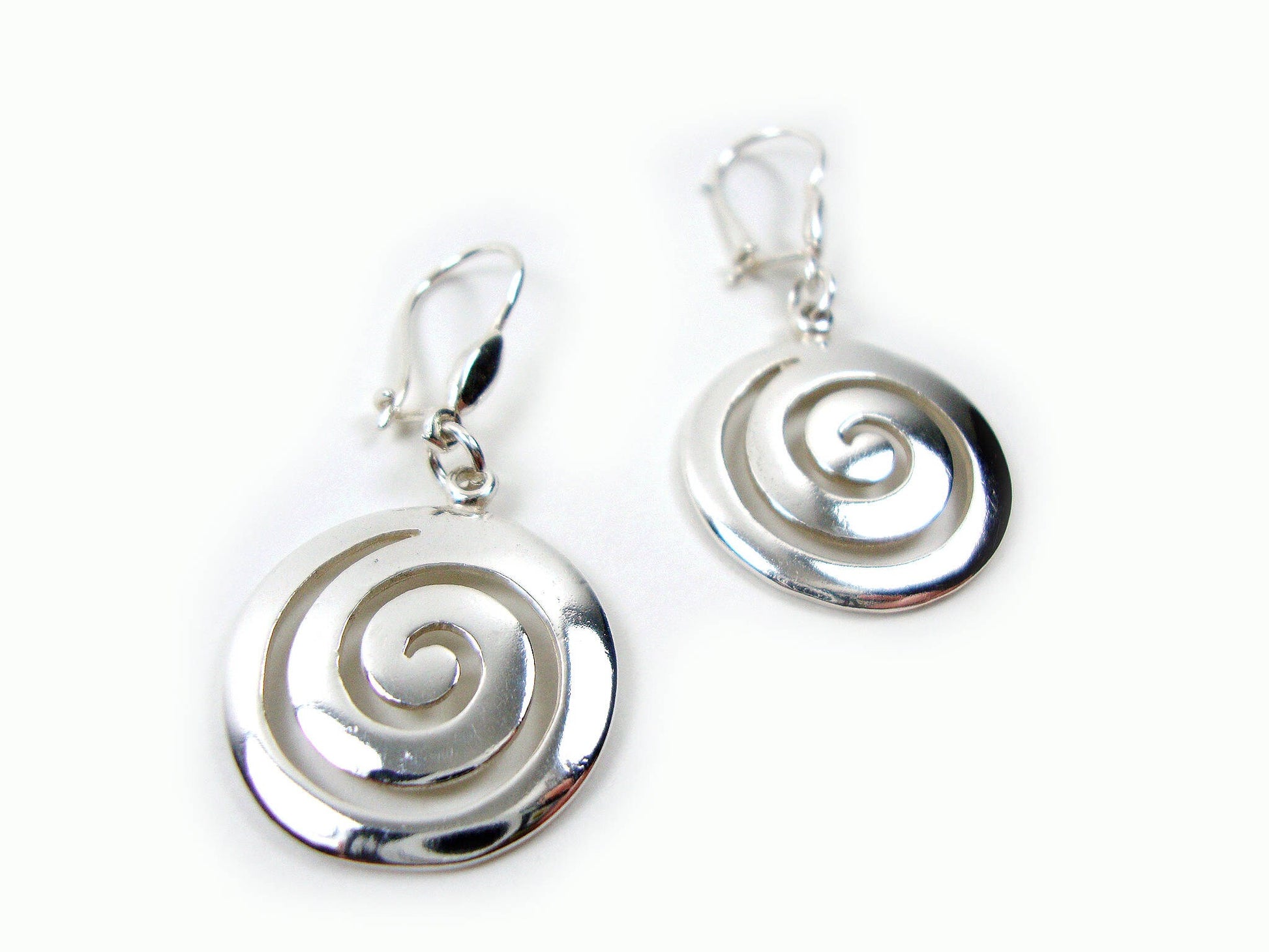 Dangle spiral Greek silver earrings on a white background.