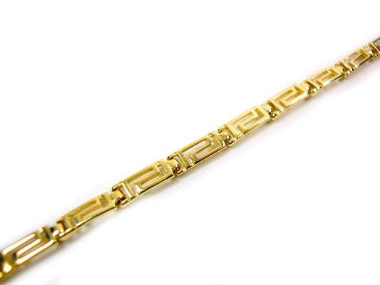 Greek Key gold plated silver bracelet on white background.