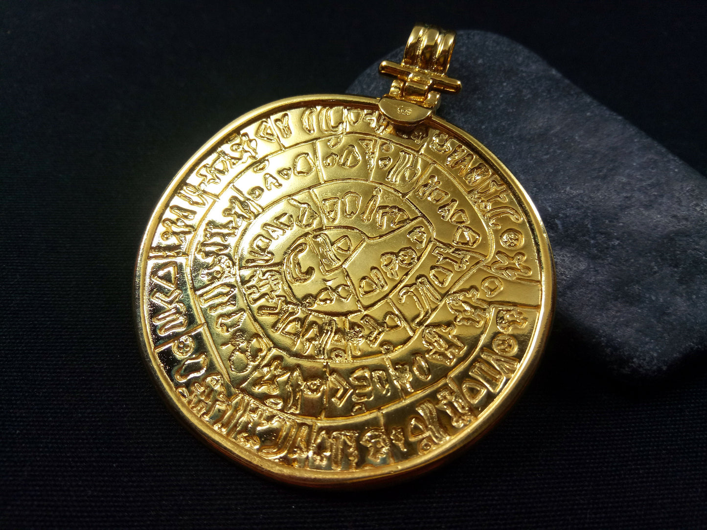 An intricate Phaistos Disc pendant in sterling silver with gold plating, measuring 54mm in diameter, a symbol of ancient Minoan civilization and Greek craftsmanship.
