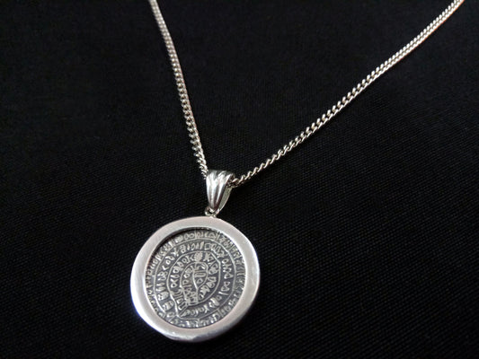 Phaistos Disc silver pendant from Greece measuring 21mm that comes with optional silver chain.