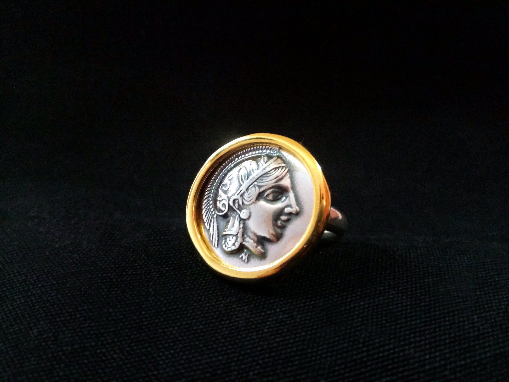 Close-up image of a Greek Silver Jewelry Tetradrachmon Coin Pendant, featuring a depiction of Goddess Athena on a Sterling Silver 925 coin with Gold Plating.