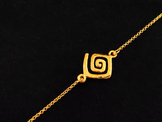 Greek Key gold plated bracelet with fine chain made of silver 925 on black background.