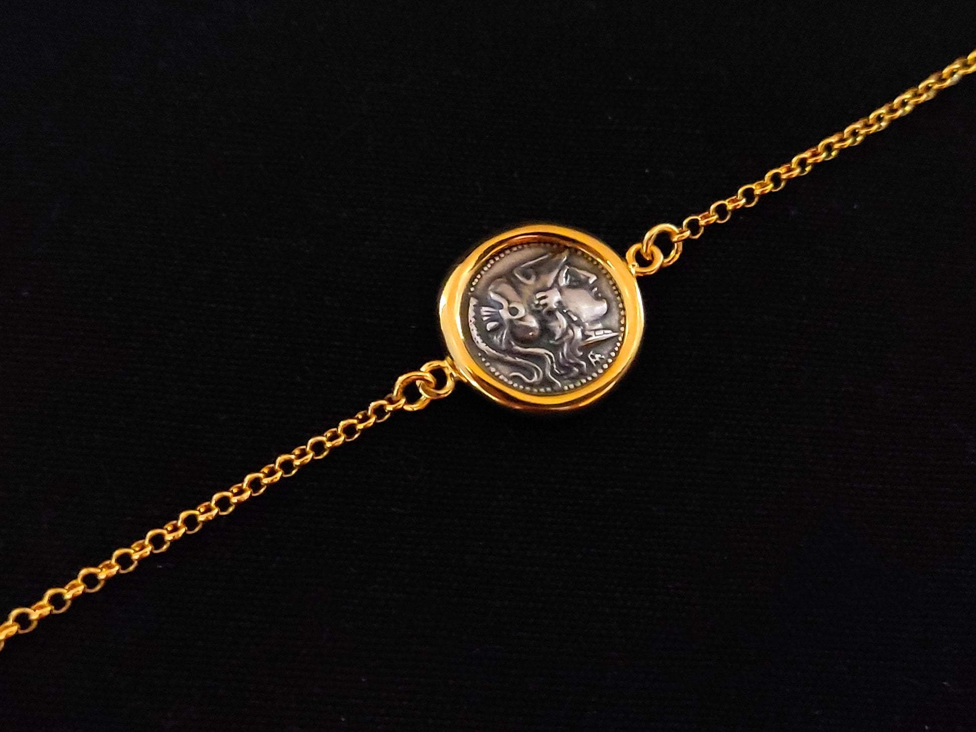 Close-up image of a Sterling Silver 925 Adjustable Bracelet adorned with a Gold-Plated 22K Ancient Greek Goddess Athena Minerva Replica Coin, showcasing intricate craftsmanship and timeless elegance.