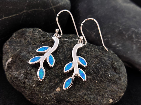 Opal leaf earrings made of Sterling Silver 925 and blue opal stones on a black rock
