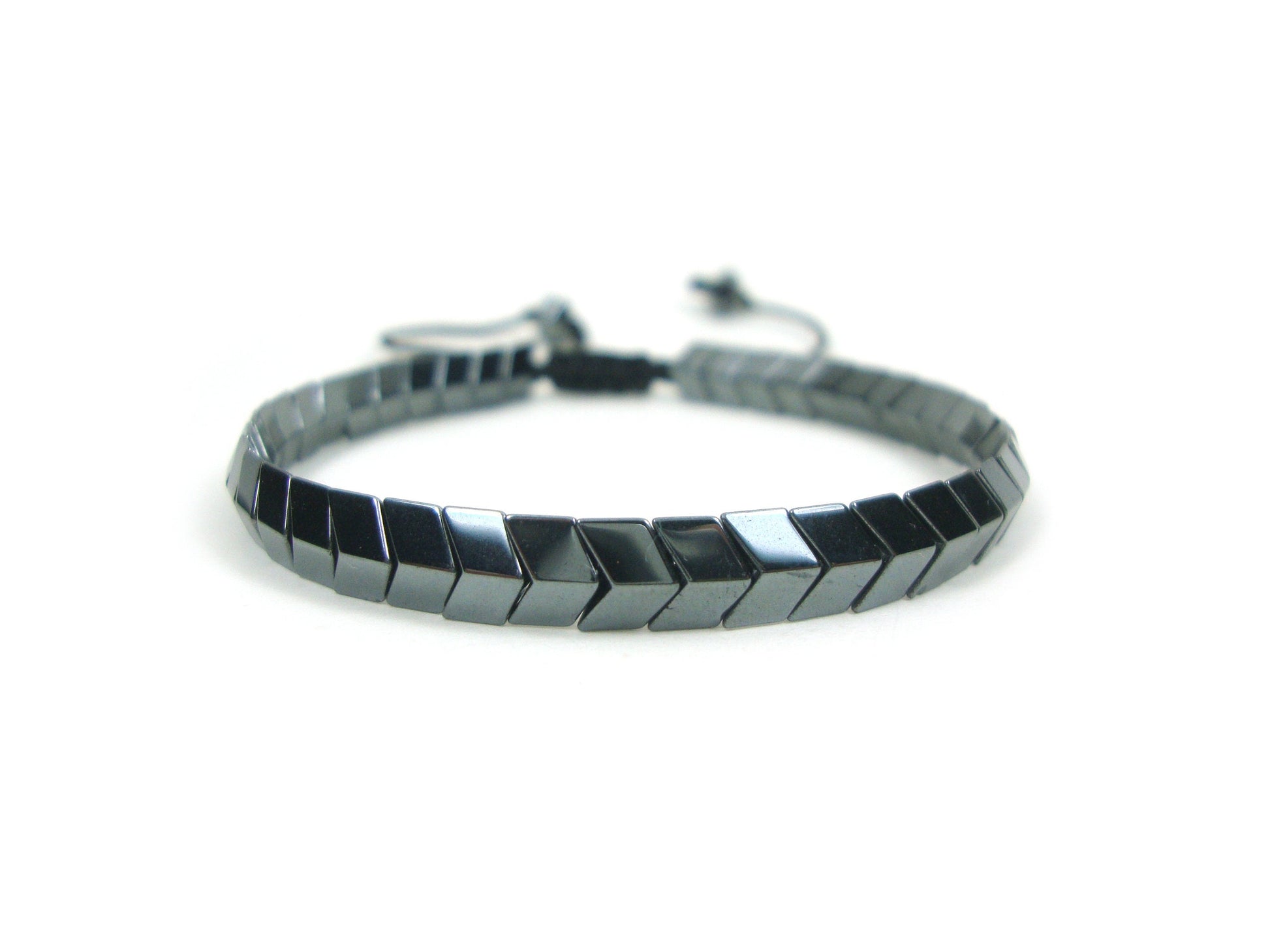 An adjustable bracelet made of natural hematite stones in an arrow shape, displayed against a white background.